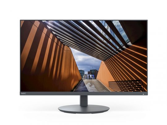 NEC flat-screen computer monitor showing a vibrant photo of an architectural structure with bold orange walls. The image on the screen features striped shadows and an outdoor walkway beneath a partly cloudy sky, highlighting the NEC monitor’s sharp display quality.