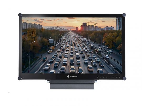 Computer monitor displaying a high-resolution image of heavy traffic on a multi-lane highway at sunset, with numerous cars lined up and city buildings visible in the background. Ideal for home office or professional workspace setups.