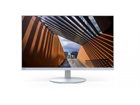 Computer-Monitor mit dünnem weißem Rahmen (Bezel), Modellname unbekannt, zeigt auf dem Display eine Architekturaufnahme mit orangefarbenen Wänden, schrägen Balken und markanten Schattenspielen durch Sonnenlicht. Der Monitor steht auf einem runden Standfuß vor weißem Hintergrund.